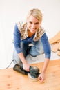 Home improvement - handywoman sanding wooden floor Royalty Free Stock Photo