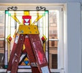 Home improvement -Hanging an art deco stained glass window inside an old fashioned wood window with old ladder