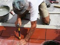 Home improvement, renovation - construction worker tiler is tiling, ceramic tile floor adhesive Royalty Free Stock Photo