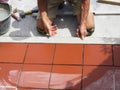 Home improvement, renovation - construction worker tiler is tiling, ceramic tile floor adhesive Royalty Free Stock Photo