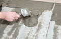 Home improvement, renovation. Construction worker is tiling, ceramic tile. Royalty Free Stock Photo