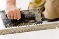 Home improvement, renovation - man laying tile Royalty Free Stock Photo