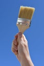 Home improvements and DIY,  hand holding paint brush Royalty Free Stock Photo