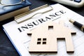 Home insurance. Policy and model of house. Royalty Free Stock Photo
