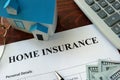 Home insurance form and dollars.