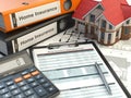 Home insurance form, house, calculator and binders, Royalty Free Stock Photo