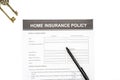 Home insurance policy document near a pen and keys