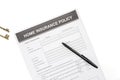 Home insurance policy form with pen and home key Royalty Free Stock Photo