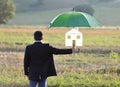 Home insurance protection concept, businessman with umbrella Royalty Free Stock Photo