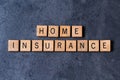 `Home Insurance` spelled out in wooden letter tiles