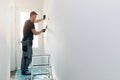 Home interior construction - worker repairing wall