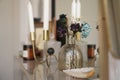 Home interior decor. Glass jar with dried flowers, vase and candle