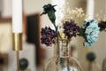 Home interior decor. Glass jar with dried flowers, vase and candle