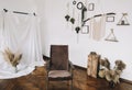 Home interior design with mock up posters on the wall, handmade macrame, brown comfortable chair. scandi-boho style.