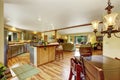 Home interior with hardwood floors and open floor plan showing dining room, kitchen, and living room. Royalty Free Stock Photo