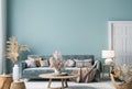 Home interior mock-up with blue sofa, wooden table and decor in blue living room