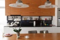 Home Interior With Open Plan Kitchen, Lounge And Dining Area. Modern lights and wooden table Royalty Free Stock Photo