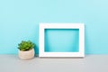 Home interior poster mock up with wooden frame, cactus in a pot, blue wall background, copy space for text and pictures Royalty Free Stock Photo