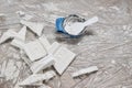 Home, interior reconstruction still life. Broken gypsum pieces of decorative stucco cornices. Bowl with white plaster