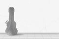 Home interior -  Silver acoustic guitar hard case in front of white wall Royalty Free Stock Photo