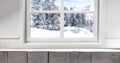 Home interior with a table and a place for an advertising product. Winter window view background.Christmas time. Royalty Free Stock Photo