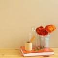 Home interior. Work and study place. note book, pencil with floral decoration on wooden desk with beige background Royalty Free Stock Photo