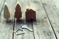 Home key with house keychain and wooden tree and home mockup on vintage wood background, property concept Royalty Free Stock Photo