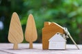 Home key with house keychain and wooden treen and home mock up on vintage wood background, property concept Royalty Free Stock Photo