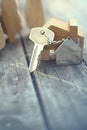 Home key with house keychain and wooden treen and home mock up on vintage wood background, property concept Royalty Free Stock Photo