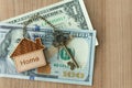 Home key with house keyring on dollar bill stack Royalty Free Stock Photo