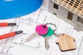 Home keys, electrical construction diagrams and small house under contruction. Building or buying home Royalty Free Stock Photo