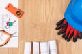 Home keys with electrical drawings, protective blue helmet with gloves and orange work tools, building home concept