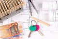 Home keys, money, electrical diagrams and work tools for engineer jobs, concept of building home cost