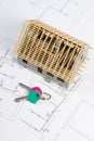 Home keys and small house under construction on electrical drawings, building home concept Royalty Free Stock Photo