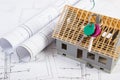 Home keys, small house under construction and electrical drawings, building home concept Royalty Free Stock Photo