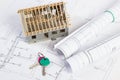 Home keys, small house under construction and electrical drawings, building home concept Royalty Free Stock Photo