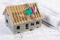 Home keys, small house under construction and electrical drawings, building home concept Royalty Free Stock Photo