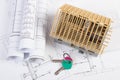 Home keys, small house under construction and electrical drawings, building home concept Royalty Free Stock Photo