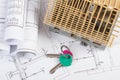 Home keys, small house under construction and electrical drawings, building home concept Royalty Free Stock Photo