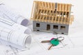 Home keys, small house under construction and electrical drawings, building home concept Royalty Free Stock Photo