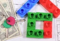 Home keys, toy blocks and currencies dollar on construction drawing of house. Building home costs Royalty Free Stock Photo