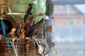 Home kitchen. Clean washed dish ware drying on a drainer mounted in kitchen. Clean dishes: spoon, plate, cup, knife, fork after