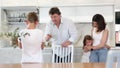 At home in kitchen, parents scold son for imprudent act committed