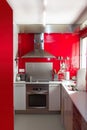 Home kitchen in red colors natural window light