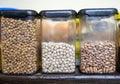 home kitchen shelf displaying assorted dried beans and lentils in jars Royalty Free Stock Photo