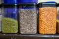 home kitchen shelf displaying assorted dried beans and lentils in jars Royalty Free Stock Photo