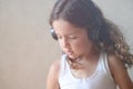 Home leiusre concept of little girl in headphones listen sound audion music with hair blown by wind during self-isolated strict