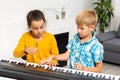 Home lesson on music for kids on the piano. The idea of activities for the child at home during quarantine. Music Royalty Free Stock Photo