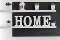 Home letters decor on white shelf