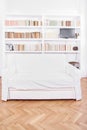 Home library with sofa or couch in white living room Royalty Free Stock Photo